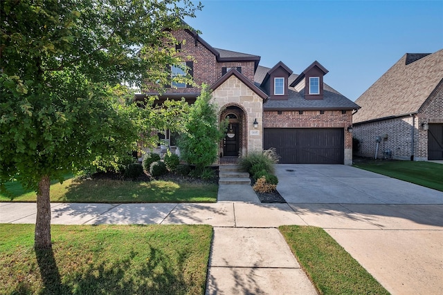 view of front of home featuring a garage and a front yard