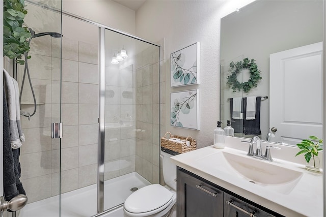 bathroom featuring vanity, toilet, and walk in shower