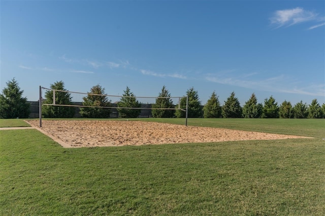 surrounding community featuring volleyball court and a lawn