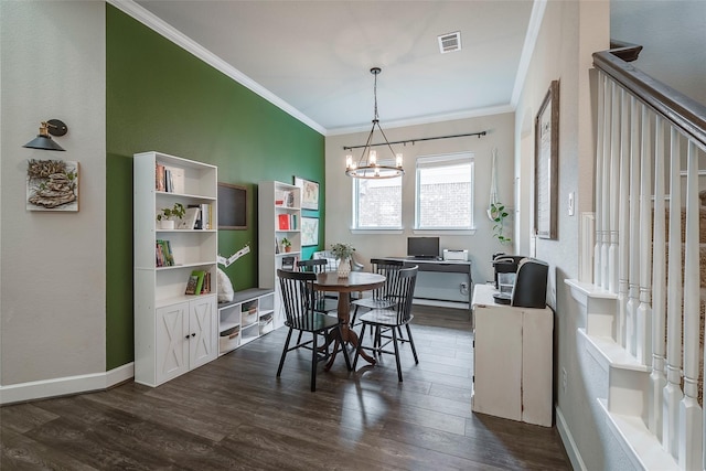 dining area with dark hardwood / wood-style flooring, crown molding, and a chandelier