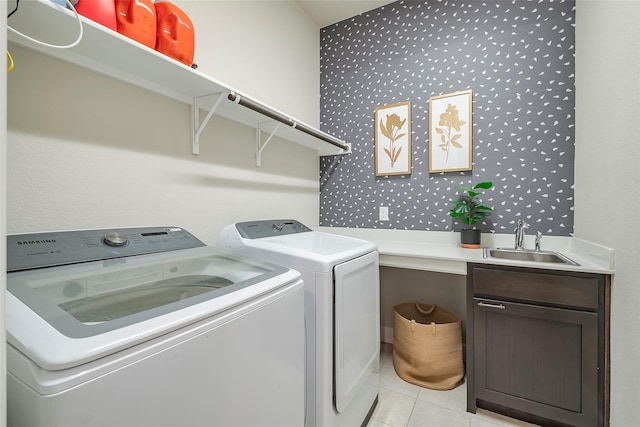 laundry room featuring sink, cabinets, separate washer and dryer, and light tile patterned flooring