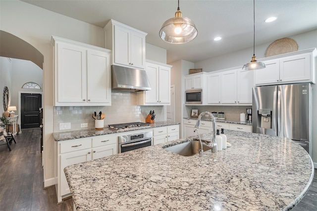 kitchen featuring sink, decorative light fixtures, white cabinetry, and stainless steel appliances