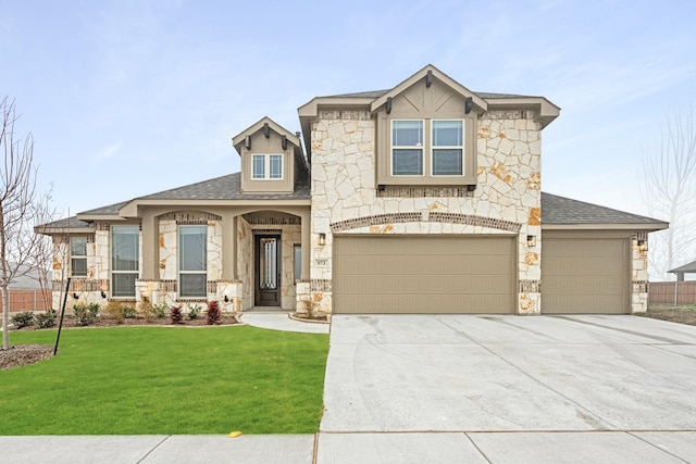 view of front of house with a garage and a front yard