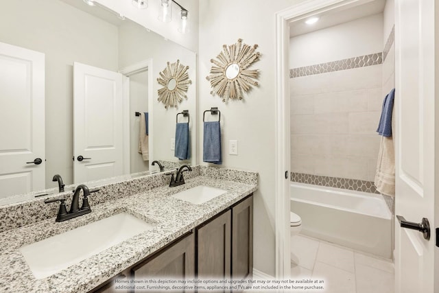 bathroom featuring a tub, tile patterned floors, vanity, and toilet