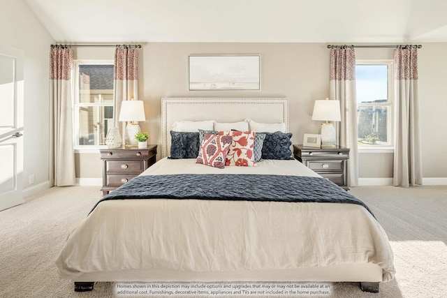 bedroom with light colored carpet and lofted ceiling