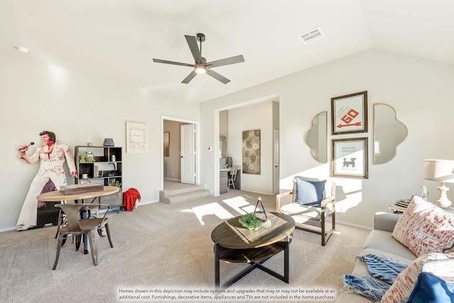 carpeted living room featuring vaulted ceiling and ceiling fan