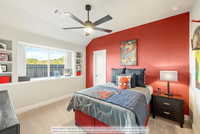 bedroom with light colored carpet, vaulted ceiling, and ceiling fan