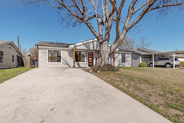 ranch-style house featuring a front yard and a carport