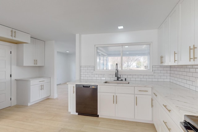 kitchen featuring black dishwasher, range, tasteful backsplash, white cabinetry, and sink