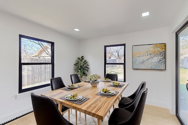 dining room featuring plenty of natural light and light wood-type flooring