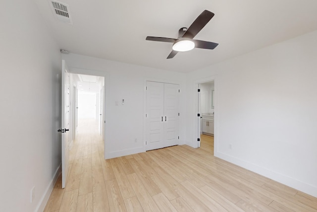 unfurnished bedroom with ceiling fan, light hardwood / wood-style floors, and a closet