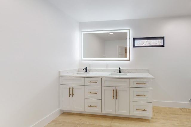 bathroom featuring wood-type flooring and vanity