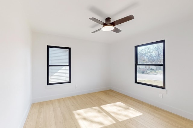 empty room with ceiling fan and wood-type flooring