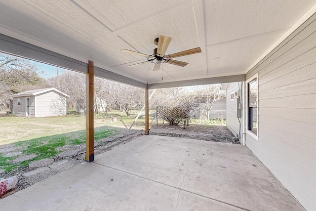 view of patio featuring a storage shed and ceiling fan