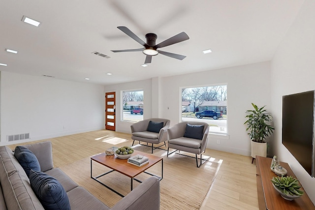 living room featuring light wood-type flooring and ceiling fan