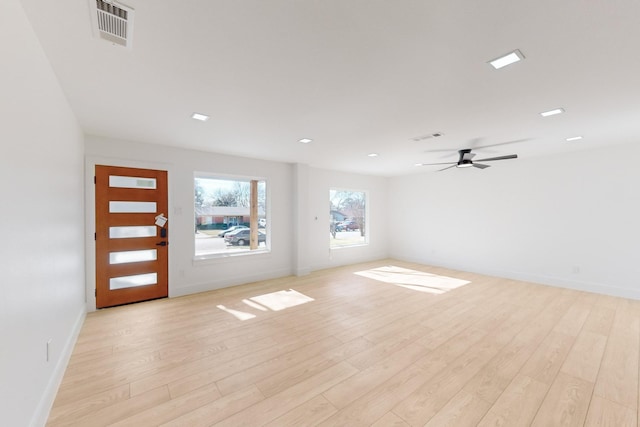 spare room featuring ceiling fan and light hardwood / wood-style floors