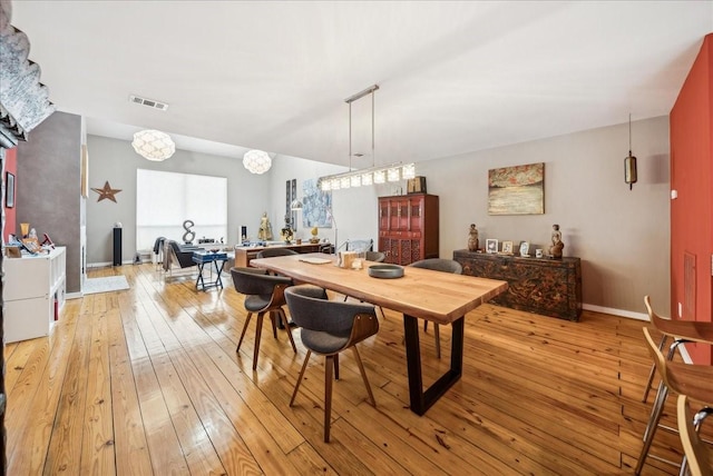 dining area with light hardwood / wood-style floors