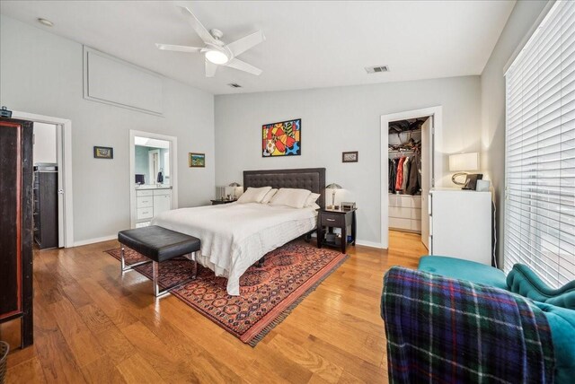 living room featuring a tile fireplace, a towering ceiling, and hardwood / wood-style floors