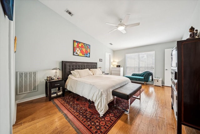 bedroom featuring ceiling fan, lofted ceiling, and light wood-type flooring