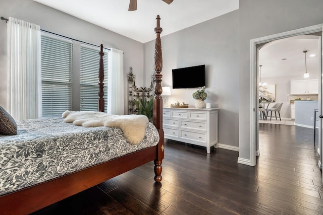 bedroom with dark hardwood / wood-style floors and ceiling fan