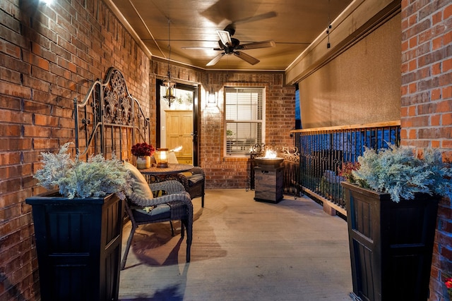 living area with ceiling fan, brick wall, hardwood / wood-style flooring, and wood ceiling