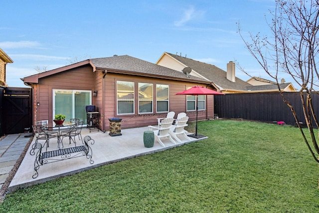 back of property with a patio and a lawn