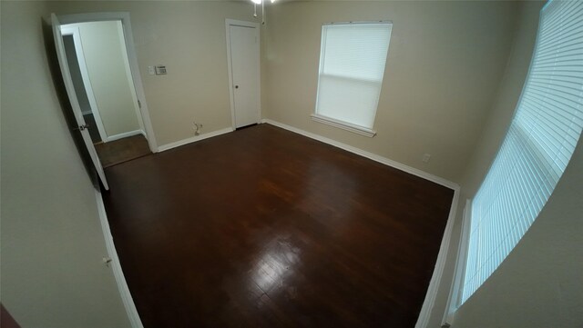 1104 Prairie Ave, Cleburne, TX 76033 - empty room with baseboards and dark wood-style flooring