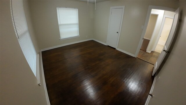 1104 Prairie Ave, Cleburne, TX 76033 - unfurnished room with dark wood-type flooring, baseboards, and ceiling fan
