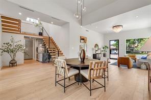 dining room with stairs and light wood-type flooring