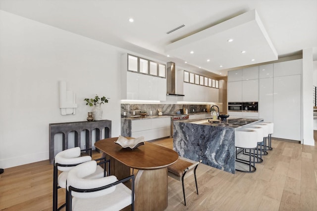 dining space featuring sink and light wood-type flooring