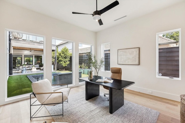 office with ceiling fan and light wood-type flooring