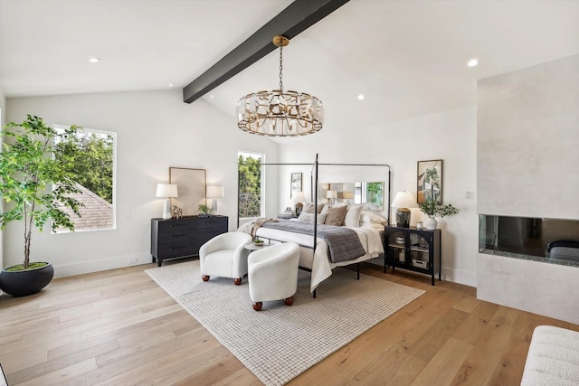 bedroom with multiple windows, vaulted ceiling with beams, a notable chandelier, and light hardwood / wood-style flooring