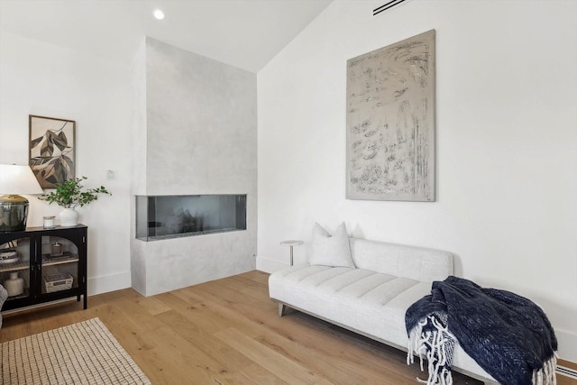 living room with hardwood / wood-style flooring and lofted ceiling