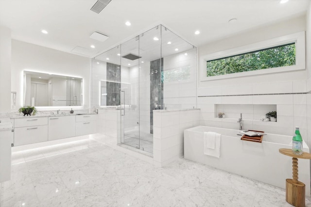 bathroom with vanity and separate shower and tub