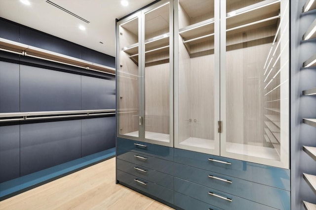 walk in closet with light wood-type flooring