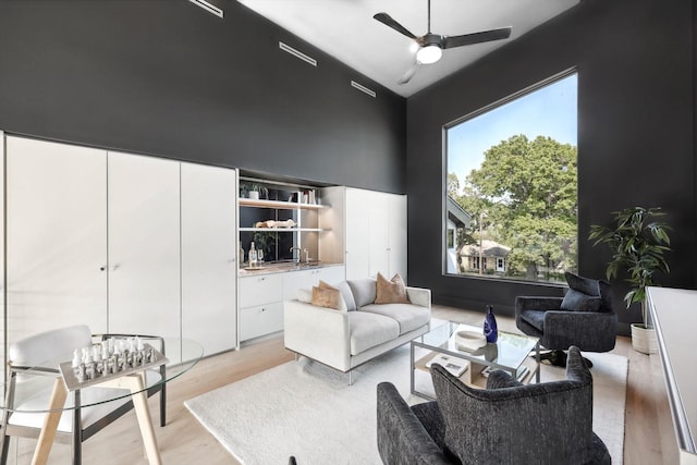 sitting room with ceiling fan and light hardwood / wood-style floors