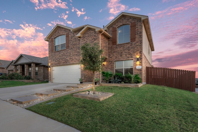 view of property featuring a garage and a lawn