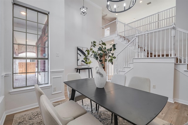 dining area featuring light hardwood / wood-style flooring and a notable chandelier