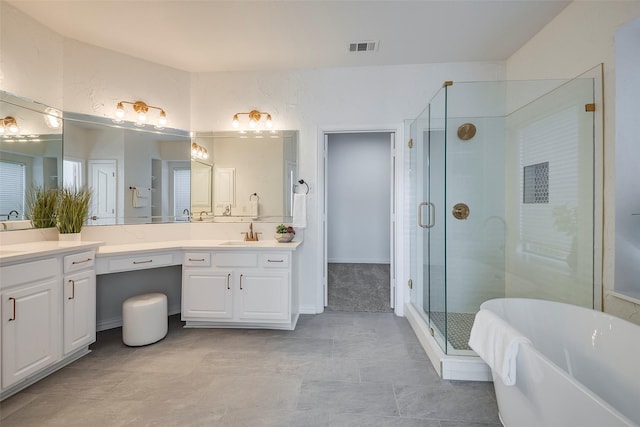 bathroom with vanity and shower with separate bathtub