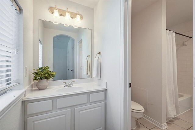 full bathroom with toilet, vanity, shower / bath combo, and tile patterned flooring