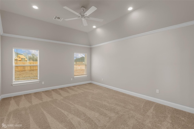 unfurnished room featuring vaulted ceiling, ornamental molding, carpet, and ceiling fan