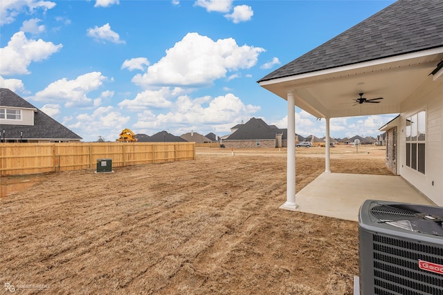 view of yard with a patio area, ceiling fan, and central air condition unit