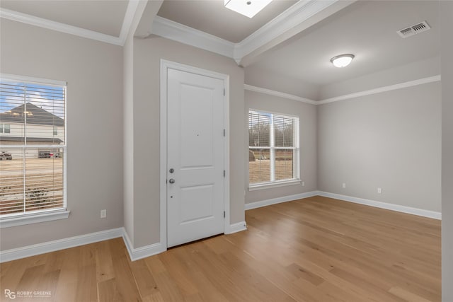 foyer entrance featuring ornamental molding and light wood-type flooring