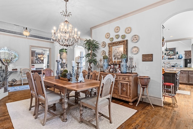 dining room with sink, dark hardwood / wood-style flooring, and a notable chandelier