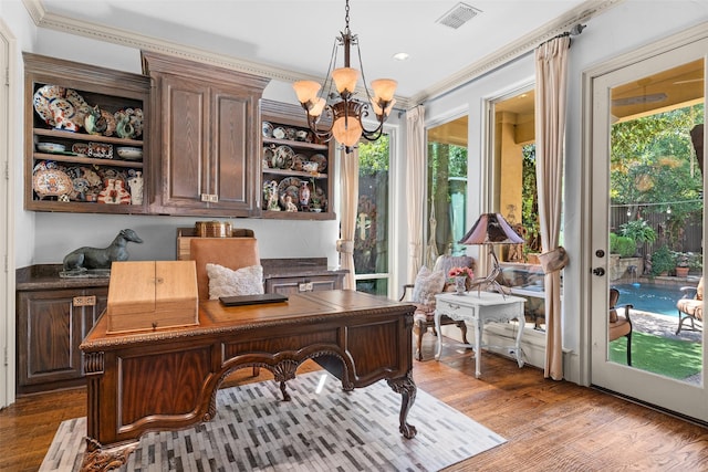 office area featuring light wood-type flooring, a chandelier, and crown molding