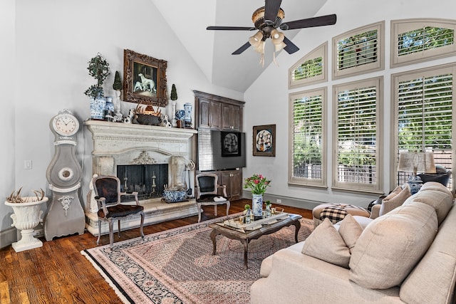 living room with dark hardwood / wood-style floors, high vaulted ceiling, and ceiling fan