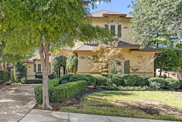 mediterranean / spanish house featuring a front yard