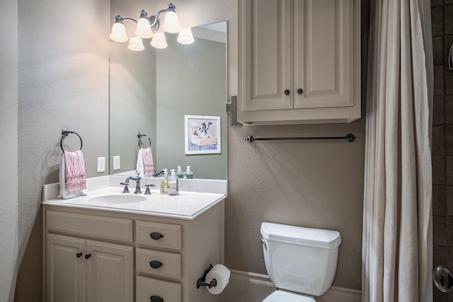 bathroom with toilet, walk in shower, and vanity