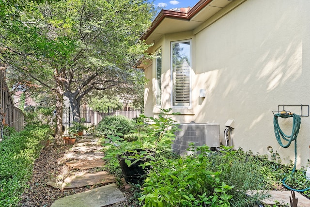 view of side of property featuring central AC unit