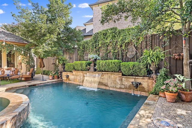 view of swimming pool with a patio area, an outdoor hangout area, and pool water feature